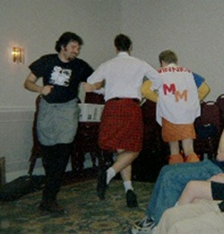 Men With Skirts dance as the band plays on